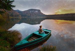 Getty_rm_woman_in_boat_looking_at_sunset